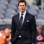 Former quarterback and current NFL announcer Tom Brady looks on before the game between the Chicago Bears and Green Bay Packers at Soldier Field.