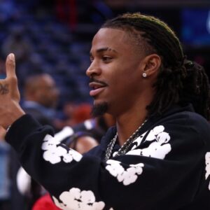 Memphis Grizzlies guard Ja Morant (12) takes videos with his phone, after the game against the Denver Nuggets at FedExForum.