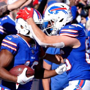 Oct 20, 2024; Orchard Park, New York, USA; Buffalo Bills tight end Dalton Kincaid (86) congratulates Buffalo Bills wide receiver Amari Cooper (18) for scoring a touchdown against the Tennessee Titans during the second half at Highmark Stadium.