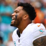 Miami Dolphins quarterback Tua Tagovailoa (1) reacts as he enters the field before the game against the Arizona Cardinals at Hard Rock Stadium.