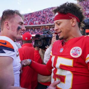 Denver Broncos quarterback Bo Nix (10) talks with Kansas City Chiefs quarterback Patrick Mahomes (15) after the game at GEHA Field at Arrowhead Stadium.