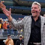 ESPN College Game Day's Pat McAfee high-fives fans as he takes the field before the game between Michigan and Texas at Michigan Stadium in Ann Arbor on Saturday, September 7, 2024.