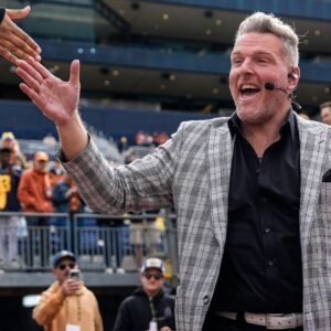 ESPN College Game Day's Pat McAfee high-fives fans as he takes the field before the game between Michigan and Texas at Michigan Stadium in Ann Arbor on Saturday, September 7, 2024.