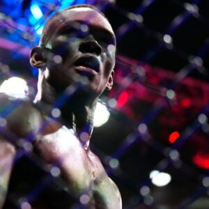 Israel Adesanya (blue gloves) reacts to defeating Alex Pereira (red gloves) during UFC 287 at Miami-Dade Arena.