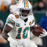 Nov 28, 2024; Green Bay, Wisconsin, USA; Miami Dolphins wide receiver Tyreek Hill (10) rushes with the football during the fourth quarter against the Green Bay Packers at Lambeau Field.