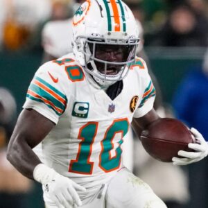 Nov 28, 2024; Green Bay, Wisconsin, USA; Miami Dolphins wide receiver Tyreek Hill (10) rushes with the football during the fourth quarter against the Green Bay Packers at Lambeau Field.