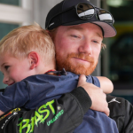 NASCAR Cup Series driver Tyler Reddick (45) hugs his son Beau, 4, after qualifying on pole position for the Brickyard 400, Saturday, July 20, 2024, at Indianapolis Motor Speedway.