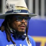 Former NFL quarterback Cam Newton watches a game between the Howard Bison and Florida A&M Rattlers in the first half at Mercedes-Benz Stadium.