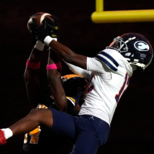 Evans cornerback Christian Scott (14) and Effingham wide receiver Trayvis Hunter (12) jump for the ball during the Evans and Effingham County football game at Evans High School on Wednesday, Oct. 9, 2024. This week marks the return of high school football after Hurricane Helene. Effingham County defeated Evans with a score of 35-7.