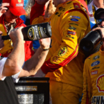 NASCAR Sprint Cup Series driver Joey Logano (22) celebrates with team owner Roger Penske in victory lane after winning the Daytona 500 at Daytona International Speedway.