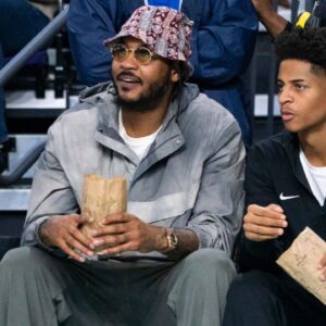 Carmelo Anthony and his son, Kiyan, watch the Don Bosco Prep Ironmen compete against the McEachern Indians in a game during the 50th annual City of Palms Classic at Suncoast Credit Union Arena in Fort Myers on Tuesday, Dec. 19, 2023. Kiyan Anthony and the Long Island Luthern Crusaders defeated Westminster Academy earlier in the day.