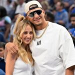 Kansas City Chiefs quarterback Patrick Mahomes and Brittany Mahomes pose in the first half between the Dallas Mavericks and the Minnesota Timberwolves during game three of the western conference finals for the 2024 NBA playoffs at American Airlines Center.