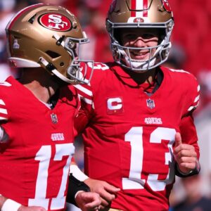 an Francisco 49ers quarterback Brock Purdy (13) smiles with quarterback Brandon Allen (17) before the game against the Cincinnati Bengals at Levi's Stadium.