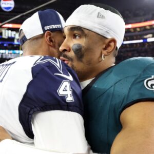 Dec 10, 2023; Arlington, Texas, USA; Dallas Cowboys quarterback Dak Prescott (4) hugs Philadelphia Eagles quarterback Jalen Hurts (1) after the game at AT&T Stadium.