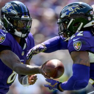 Sep 15, 2024; Baltimore, Maryland, USA; Baltimore Ravens quarterback Lamar Jackson (8) hands off to running back Derrick Henry (22) during the first half against the Las Vegas Raiders at M&T Bank Stadium.