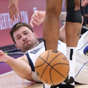Dallas Mavericks guard Luka Doncic (77) goes to the floor for a ball against the Utah Jazz during the third quarter at Delta Center