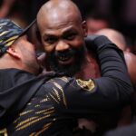 Jon Jones (red gloves) enters prior to fighting Stipe Miocoic (blue gloves) in the heavyweight bout during UFC 309 at Madison Square Garden.