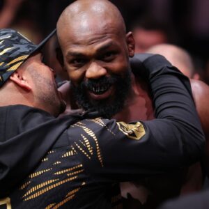 Jon Jones (red gloves) enters prior to fighting Stipe Miocoic (blue gloves) in the heavyweight bout during UFC 309 at Madison Square Garden.