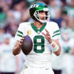 New York Jets quarterback Aaron Rodgers (8) passes against the Arizona Cardinals during the second half at State Farm Stadium.