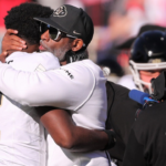 Colorado football coach Deion Sanders hugs his son, Shedeur Sanders, before facing Texas Tech in a Big 12 football game