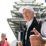 Roger Penske greets fans Saturday, July 20, 2024, during qualifying for the Brickyard 400 at Indianapolis Motor Speedway.