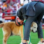 ESPN commentator Kirk Herbstreit hugs his dog Ben before the game between the Oklahoma Sooners and Tennessee Volunteers at Gaylord Family-Oklahoma Memorial Stadium.