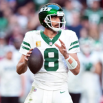 New York Jets quarterback Aaron Rodgers (8) passes against the Arizona Cardinals during the second half at State Farm Stadium.