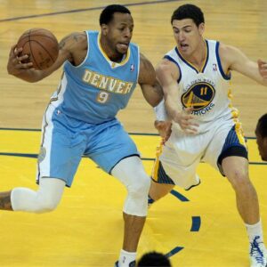 Golden State Warriors shooting guard Klay Thompson (11) defends Denver Nuggets shooting guard Andre Iguodala (9) on the drive during the first quarter of game six of the first round of the 2013 NBA Playoffs at Oracle Arena.