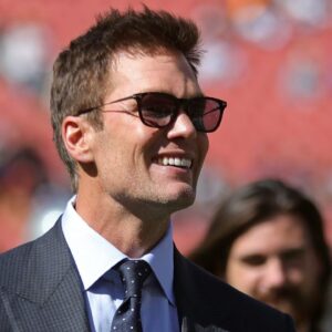 NFL legend Tom Brady is all smiles before an NFL football game at Huntington Bank Field, Sunday, Sept. 8, 2024, in Cleveland, Ohio.