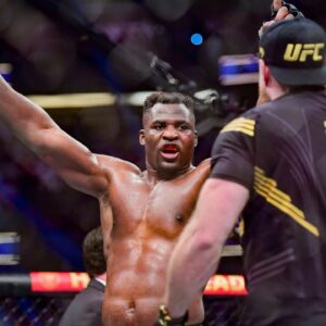 Francis Ngannou (red gloves) celebrates after the fight against Ciryl Gane (blue gloves) during UFC 270 at Honda Center.