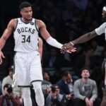 Milwaukee Bucks forward Giannis Antetokounmpo (34) slaps hands with forward Bobby Portis (9) during the first half against the Brooklyn Nets at Barclays Center.