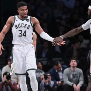 Milwaukee Bucks forward Giannis Antetokounmpo (34) slaps hands with forward Bobby Portis (9) during the first half against the Brooklyn Nets at Barclays Center.