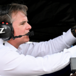 Jeff Gordon sits in the pit box of NASCAR Cup Series driver William Byron (24) ahead of the Brickyard 400, Sunday, July 21, 2024, at Indianapolis Motor Speedway.