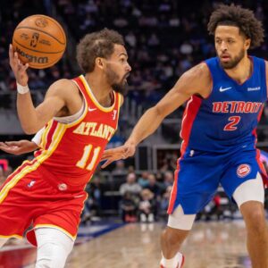 Atlanta Hawks guard Trae Young (11) moves the ball up court next to Detroit Pistons guard Cade Cunningham (2) during the first half at Little Caesars Arena.