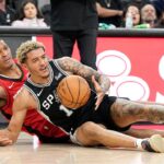 Houston Rockets forward Jabari Smith (18) and San Antonio Spurs forward Jeremy Sochan (10) battle for a loose ball during the first half at Frost Bank Center
