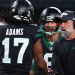 New York Jets wide receiver Davante Adams (17), quarterback Aaron Rodgers (8) and interim head coach Jeff Ulbrich celebrate Adams touchdown against the Houston Texans during the second half at MetLife Stadium.