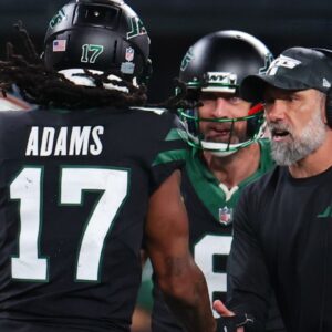New York Jets wide receiver Davante Adams (17), quarterback Aaron Rodgers (8) and interim head coach Jeff Ulbrich celebrate Adams touchdown against the Houston Texans during the second half at MetLife Stadium.