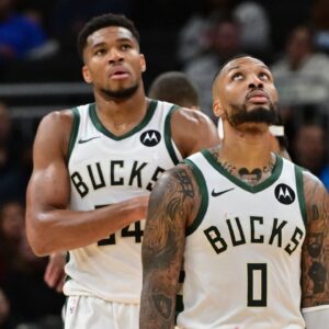 Milwaukee Bucks forward Giannis Antetokounmpo (34) and guard Damian Lillard (0) look on in the second quarter against the Chicago Bulls at Fiserv Forum.