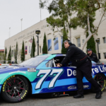 The car of NASCAR Cup Series driver Carson Hocevar (77) is brought out to the staging area during practice at Los Angeles Memorial Coliseum.