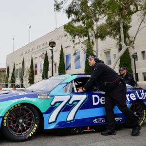 The car of NASCAR Cup Series driver Carson Hocevar (77) is brought out to the staging area during practice at Los Angeles Memorial Coliseum.
