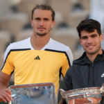 Carlos Alcaraz of Spain and Alexander Zverev of Germany pose with their trophies at the trophy presentation on day 15 of Roland Garros at Stade Roland Garros.