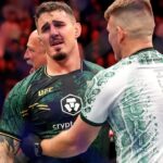 Tom Aspinall (blue gloves) reacts to beating Sergei Pavlovich (red gloves) during UFC 295 at Madison Square Garden.