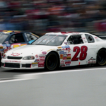 Pole-sitter Casey Atwood (28) surges past a slower car as he stretches his lead during the early part of the Busch Series' BellSouth/Opryland 320 at the Nashville Speedway March 15, 1998. Atwood, who at 17 became the youngest pole-sitter in the 17-year history of the NASCAR Busch Series, finished runner-up in the nationally televised race.