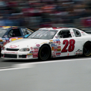 Pole-sitter Casey Atwood (28) surges past a slower car as he stretches his lead during the early part of the Busch Series' BellSouth/Opryland 320 at the Nashville Speedway March 15, 1998. Atwood, who at 17 became the youngest pole-sitter in the 17-year history of the NASCAR Busch Series, finished runner-up in the nationally televised race.