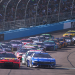 Cars race in a pack as the caution flag comes out during the Shriners Children's 500 at Phoenix Raceway.