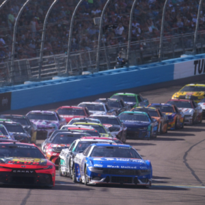 Cars race in a pack as the caution flag comes out during the Shriners Children's 500 at Phoenix Raceway.