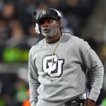 Colorado Buffaloes head coach Deion Sanders walks the sidelines in the second half against the Cincinnati Bearcats at Folsom Field.
