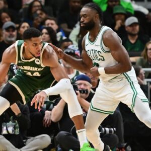 Milwaukee Bucks forward Giannis Antetokounmpo (34) is guarded by Boston Celtics forward Jaylen Brown (7) in the fourth quarter at Fiserv Forum.