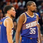 Phoenix Suns guard Devin Booker (1) and forward Kevin Durant (35) react after a time out late in the second half during a game against the Portland Trail Blazers at Footprint Center.