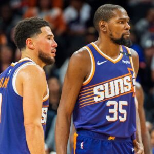 Phoenix Suns guard Devin Booker (1) and forward Kevin Durant (35) react after a time out late in the second half during a game against the Portland Trail Blazers at Footprint Center.